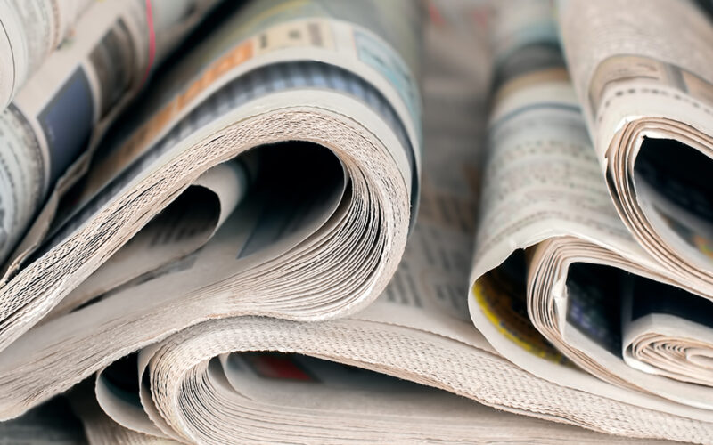 Newspapers, world news information concept, close-up, panoramic