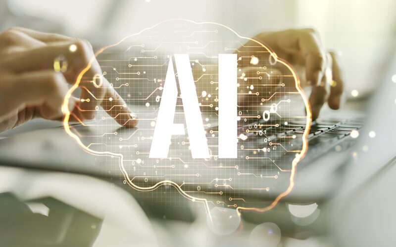 Double exposure of creative artificial Intelligence symbol with hands typing on laptop on background. Neural networks and machine learning concept